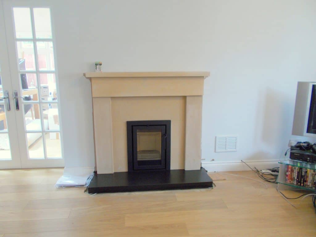 Contura i4 in bathstone fireplace surround.