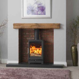 Fireline Woodtec 5kw wood burning stove in a chamber with a wooden beam above