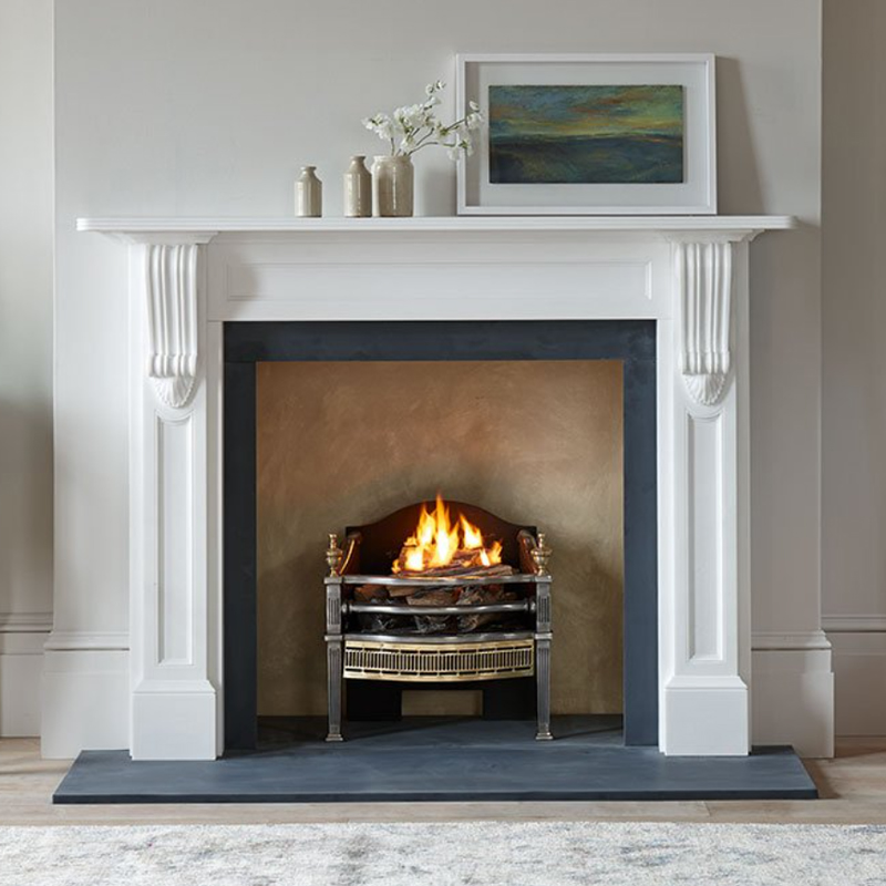 Ornate victorian white marble fireplace with a free staning open fire basket.