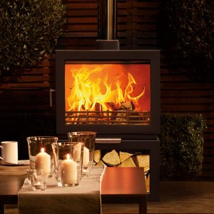 chesneys clean burn sl wood burning stove outdoors burning with table infront.