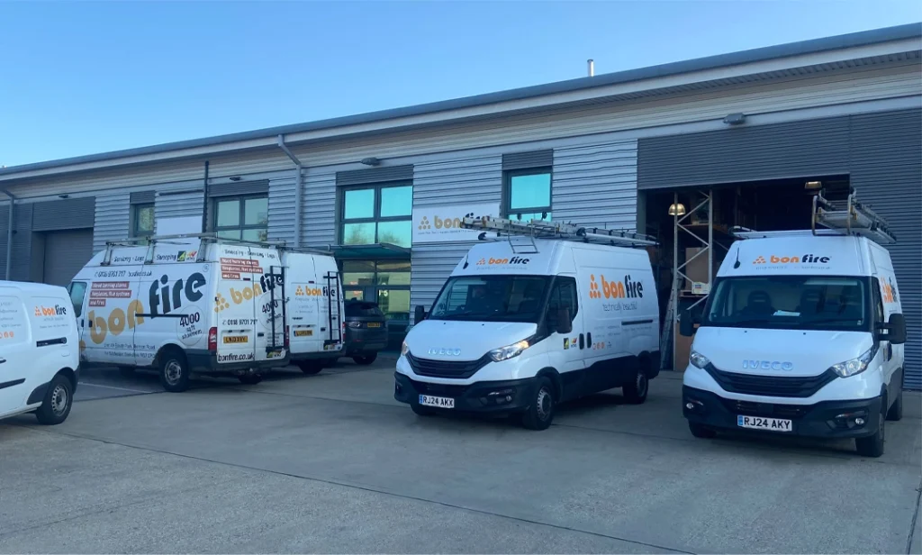 Exterior of Bonfire fireplace and stove showroom in Reading, Berkshire, with company vans parked outside.