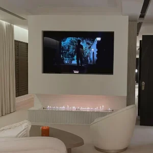 Molly-Mae Hague bedroom bioethanol media wall fireplace with linear Decoflame-style burner and recessed TV alcove