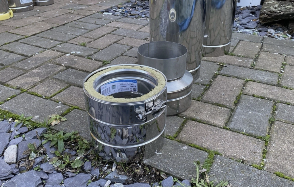 Open-ended clip on a stainless steel twin wall flue system