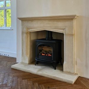 Balanced flue gas stove fireplace installation with Bath Stone surround in a Surrey property