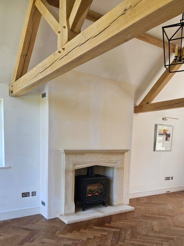 Bath Stone fireplace with Huntingdon 40 balanced flue gas stove installed in a Surrey home