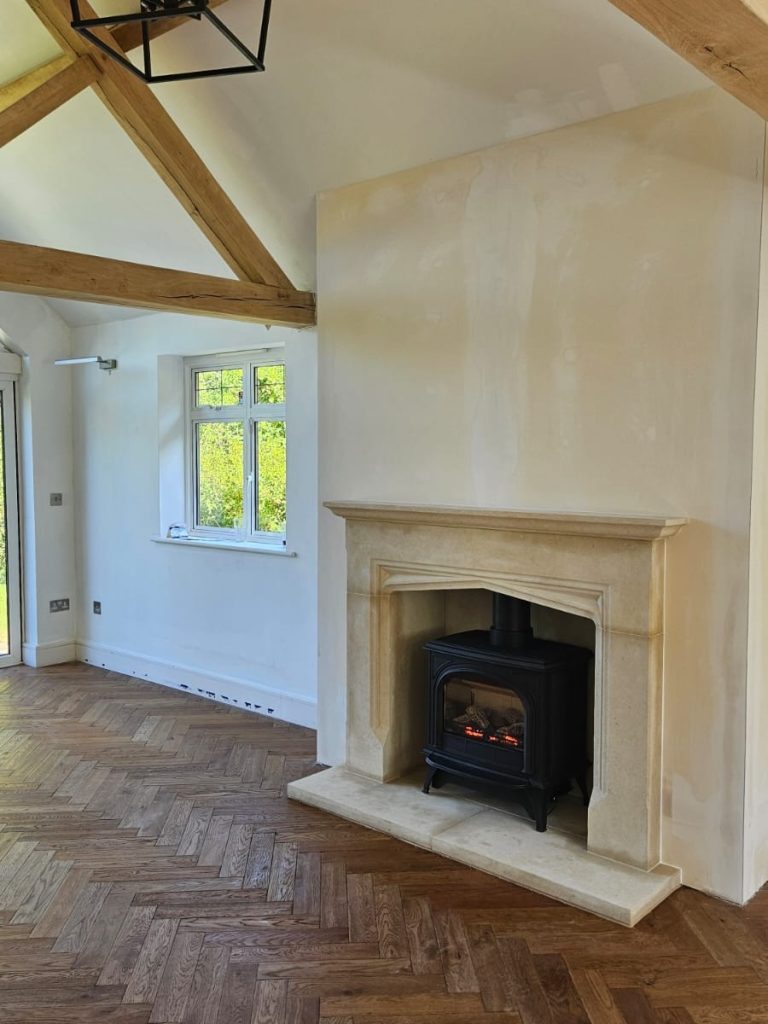 Bespoke false chimney breast with Bath Stone fireplace and balanced flue gas stove in Surrey