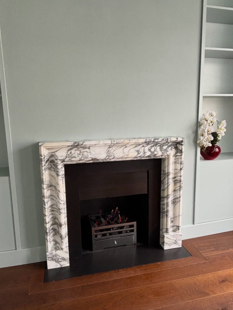 DFE gas fire with Soho fire basket set inside an Arabescato marble fireplace in Fulham