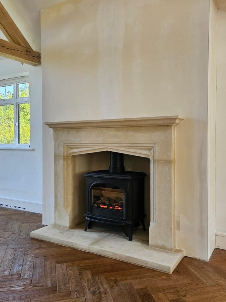 Hardwick Bath Stone fireplace surround with matching hearths and chamber linings in Surrey
