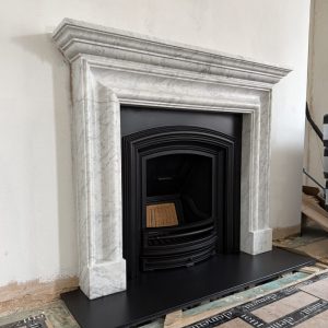 Bespoke Carrara marble fireplace and cast iron insert installed in Mayfair London